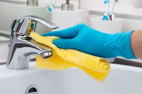 Cleaner using advanced equipment in a modern London kitchen